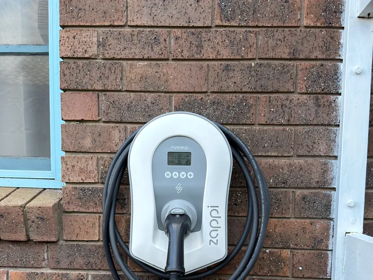 White myenergi Zappi installed on a brick wall
