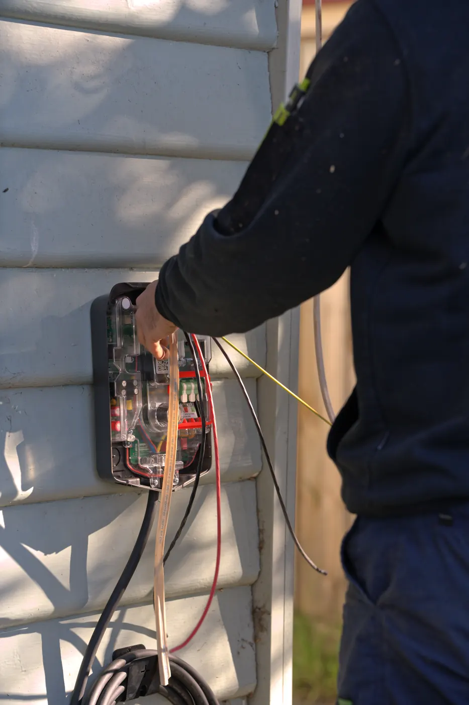 Mitch Mathie running EV charger cabling under a home